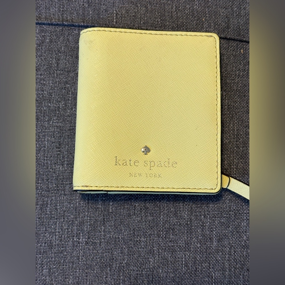 Kate Spade small slim bifold wallet in butter yellow saffiano leather
